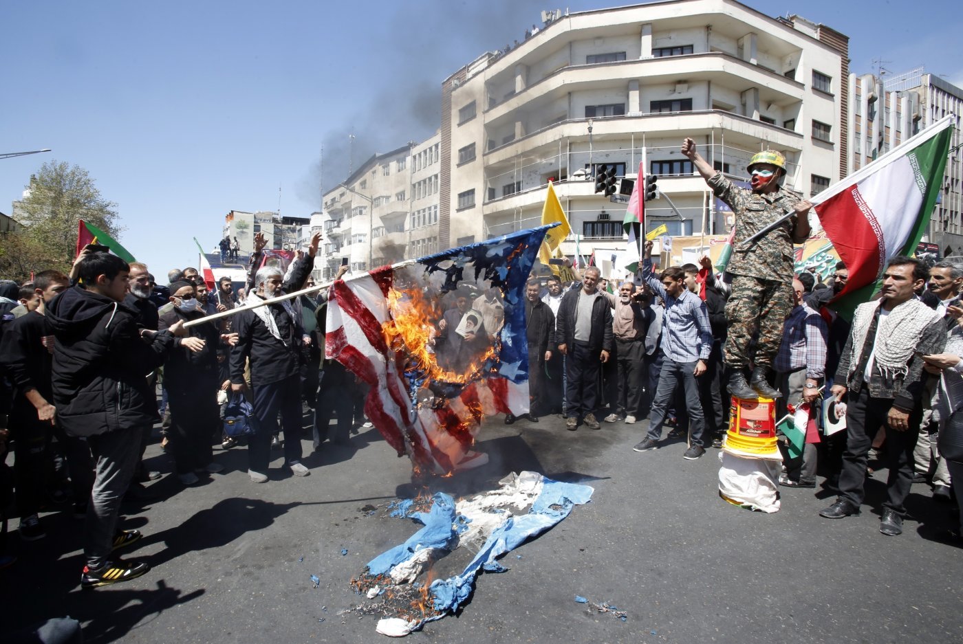 Des Iraniens brûlant des drapeaux israéliens et le 5 avril à Téhéran.